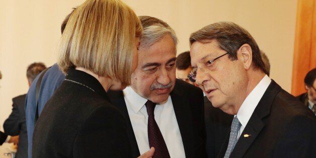 GENEVA, SWITZERLAND - JANUARY 12: Turkish Cypriot leader Mustafa Akinci (C) talks with High Representative of the European Union for Foreign Affairs and Security Policy, Federica Mogherini (L) and Greek Cypriot leader Nicos Anastasiades (R) during the fourth day of Cyprus talks at United Nations Office in Geneva, Switzerland on January 12, 2017. (Photo by Presidency of Turkish Cypriot / Artun Korudag/Anadolu Agency/Getty Images)