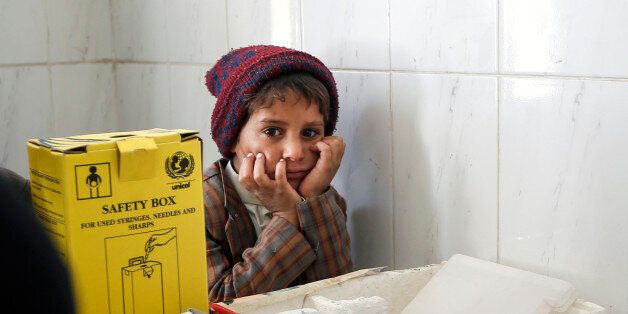 A Yemeni child looks at a doctor at a medical center in Bani Hawat, on the outskirts of the Yemeni capital Sanaa, on January 9, 2017.The UN children's fund (UNICEF) reported in December 2016 that nearly 2.2 million Yemeni children are acutely malnourished due to the near-collapse of the health care system over two years of escalating conflict. At least 462,000 are suffering from severe acute malnutrition, as food supplies have been disrupted by the devastating war between the Saudi-backed government and Shiite rebels, the agency said. / AFP / Mohammed HUWAIS (Photo credit should read MOHAMMED HUWAIS/AFP/Getty Images)