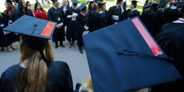 Graduating students wear red tape on their caps in solidarity with victims of sexual abuse during the 363rd Commencement Exercises at Harvard University in Cambridge, Massachusetts May 29, 2014. REUTERS/Brian Snyder (UNITED STATES - Tags: EDUCATION)