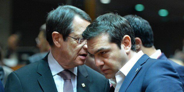 BRUSSELS, BELGIUM - MARCH 17: Greek Prime Minister Alexis Tsipras (R) and Greek-Cypriot leader Nicos Anastasiades talk together on the first day of two days long European Union (EU) Summit at the Council of the European Union in Brussels, Belgium on March 17, 2016. (Photo by Dursun Aydemir/Anadolu Agency/Getty Images)