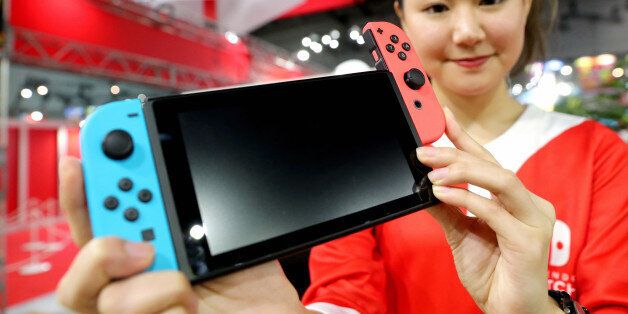 TOKYO, JAPAN - JANUARY 13: (CHINA OUT, SOUTH KOREA OUT) A staff displays the new game console 'Nitendo Switch' during its unveiling event on January 13, 2017 in Tokyo, Japan. The console will be on sale on March 3 in Japan, United States and Europe at the price of 300 U.S. dollars. (Photo by The Asahi Shimbun via Getty Images)