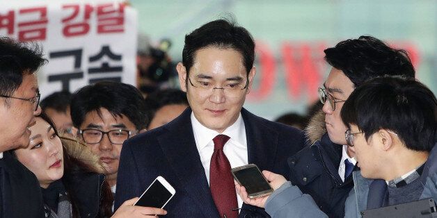 Lee Jae Yong, vice chairman of Samsung Electronics Co., speaks to reporters as he appears at the South Korean special prosecutor's office in Seoul on Jan. 12, 2017, for questioning over the Samsung group's alleged financial support for President Park Geun Hye's confidante Choi Soon Sil in return for business favors. (Photo by Pool/Kyodo News via Getty Images)