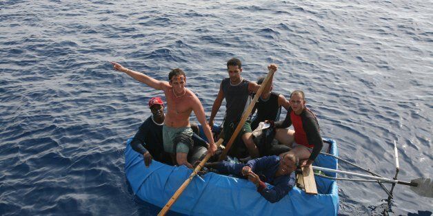 AT SEA - JULY 2007: Cubans 30 miles off the coast of the United States try to reach Florida in a tiny boat on July 30, 2007 in the Atlantic Ocean. (Photo by Ronald C. Modra/Sports Imagery/Getty Images)
