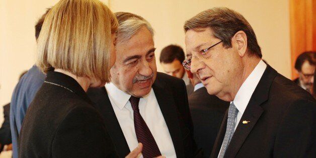 GENEVA, SWITZERLAND - JANUARY 12: Turkish Cypriot leader Mustafa Akinci (C), Greek Cypriot leader Nicos Anastasiades (R) and High Representative of the European Union for Foreign Affairs and Security Policy, Federica Mogherini (L) are seen during the fourth day of Cyprus talks at United Nations Office in Geneva, Switzerland on January 12, 2017. (Photo by Presidency of Turkish Cypriot / Artun Korudag/Anadolu Agency/Getty Images)