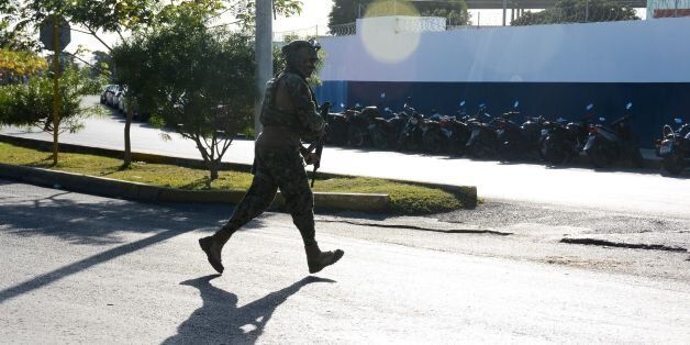 A marine arrives at the place where a shooting erupted after an attack against the building of the Quintana Roo State Prosecution, in Cancun, Mexico, on January 17, 2017.The shooting happened as Mexican authorities investigate whether a feud over local drug sales was behind a nightclub shooting that killed three foreigners and two Mexicans at a popular beach resort. Monday's shooting at the Blue Parrot club during the BPM electronic music festival rocked Playa del Carmen, a usually peaceful Caribbean seaside town. / AFP / STR (Photo credit should read STR/AFP/Getty Images)