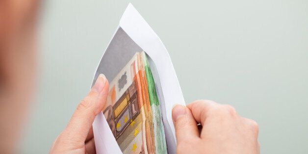 Close-up Of Person Checking Out Envelope With Cash