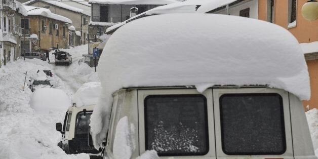 People walk in the snow in Montereale's main street, near Amatrice, after a 5.7-magnitude earthquake struck the region, on January 18, 2017.Central Italy was left reeling again on January 18, 2017 as a new wave of earthquakes brought fresh terror to a snowbound mountainous area still recovering from deadly tremors last year. Four shocks measuring more than five magnitude struck in the space of four hours with the epicentres all close to the town of Amatrice, where nearly 300 people died in an earthquake in August. / AFP / ANDREAS SOLARO (Photo credit should read ANDREAS SOLARO/AFP/Getty Images)