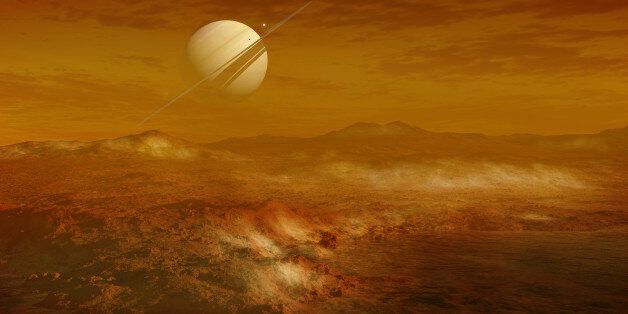 Saturn is seen here in the background from the enigmatic moon Titan, which is the second largest moon in the solar system, with a diameter of about 5 150 km. It has a highly thick, orange atmosphere that covers the entire surface. There are many different kinds of carbohydrates in the atmosphere, but nitrogen is the dominant substance. Here you see a lake of ethane, and some freshly fallen ice on the surface. In actuality the atmosphere is so thick you would not be able to see Saturn this clearly.