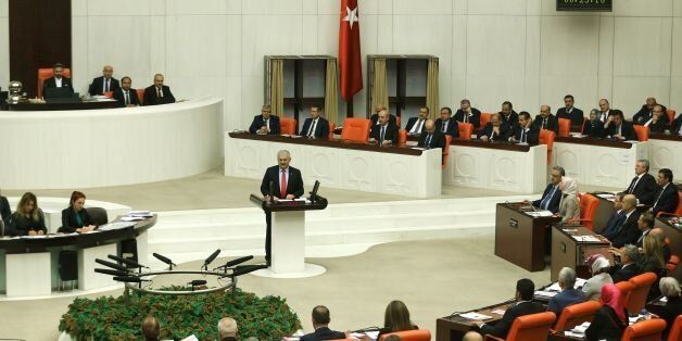 Turkish Prime Minister Binali Yildirim delivers a speech during the parliamentary session for the debates on a new draft constitution at the Turkish Grand National Assembly (TBMM) in Ankara on January 9, 2017.Turkey's parliament began debating a controversial new draft constitution aimed at expanding the powers of the presidency under Recep Tayyip Erdogan. / AFP / Adem ALTAN (Photo credit should read ADEM ALTAN/AFP/Getty Images)
