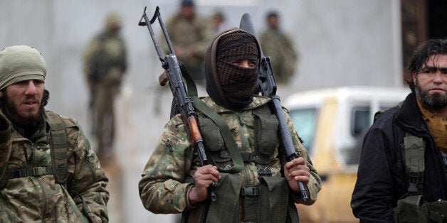 A rebel fighter carries his weapons on the outskirts of the northern Syrian town of al-Bab, Syria January 15, 2017. REUTERS/Khalil Ashawi