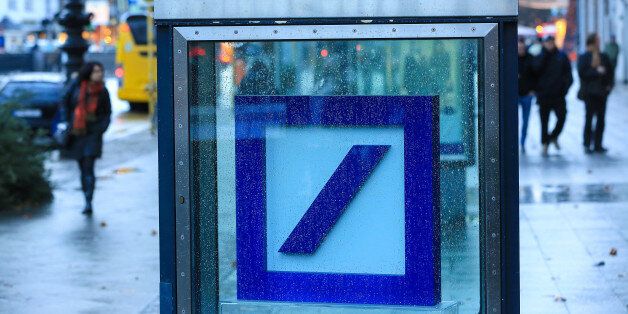A Deutsche Bank AG logo sits inside a glass display case outside a bank branch in Berlin, Germany, on Wednesday, Jan. 4, 2017. Germany had another year of firm growth in 2016 and should continue to be propelled in 2017 by consumer spending. Photographer: Krisztian Bocsi/Bloomberg via Getty Images