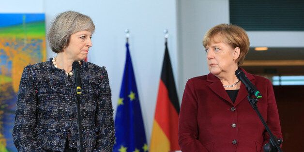 Theresa May, U.K. prime minister, and Angela Merkel, Germany's chancellor, pause during a news conference at the Chancellery in Berlin, Germany, on Friday, Nov. 18, 2016. A smooth Brexit is in the interests of the U.K., Germany and all Britain's partners, May said. Photographer: Krisztian Bocsi/Bloomberg via Getty Images