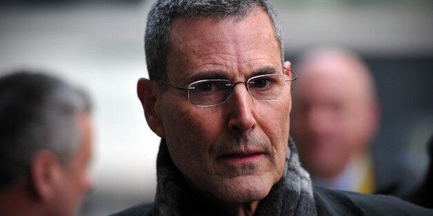 Israeli entertainer Uri Geller arrives to attend a hearing in civil cases taken against Rupert Murdoch's News Group Newspapers over phone hacking at the High Court in central London on February 8, 2013. Geller, was one of 17 people who settled their claims at London's High Court on February 8 brought against Rupert Murdoch's News Group Newspapers, publishers of the now-defunct News of the World tabloid newspaper, over phone hacking. Revelations that the News of the World had hacked celebrities led Murdoch to shut down the tabloid in July 2011. AFP PHOTO / CARL COURT (Photo credit should read CARL COURT/AFP/Getty Images)