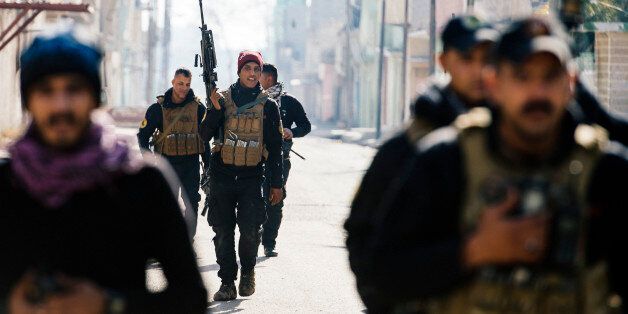 Members of the Iraqi special forces Counter Terrorism Service (CTS) patrol in Mosul's al-Jazair neighbourhood as they look for Islamic State (IS) group fighters on January 17, 2017, during an ongoing military operation against the jihadists.Iraqi forces battling the Islamic State group in Mosul retook an area where the jihadists levelled one of the city's most well-known shrines in 2014, officials said. / AFP / Dimitar DILKOFF (Photo credit should read DIMITAR DILKOFF/AFP/Getty Images)