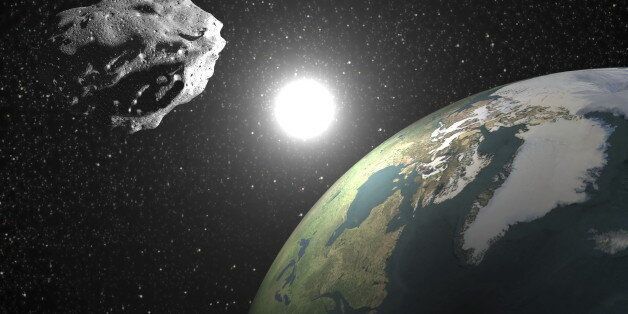 One asteroid into universe near earth planet, sun in the background - Elements of this image furnished by NASA