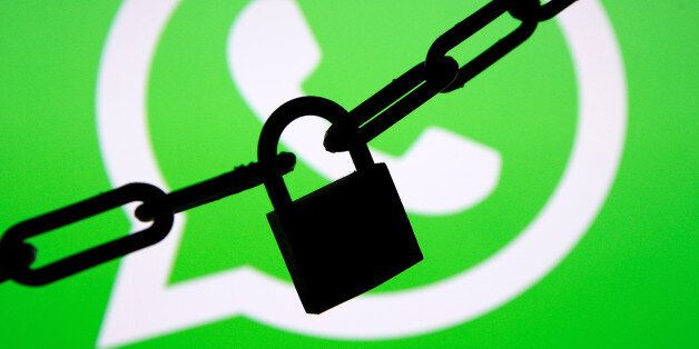 A photo illustration shows a chain and a padlock in front of a displayed Whatsapp logo January 13, 2017....