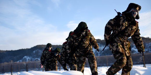 DAXINGANLING, CHINA - DECEMBER 31: Frontier soldiers patrol at the temperature of minus 30 degrees Celsius during the first day of New Year holiday on December 31, 2016 in Daxinganling, Heilongjiang Province of China. To guarantee the border security, frontier soldiers stay on their duties during holiday in winter. (Photo by VCG/VCG via Getty Images)