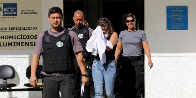 Francoise Souza Oliveira, 40, wife of Greek Ambassador for Brazil Kyriakos Amiridis, is escorted by police officers as she is transferred from the police station to a jail in Belford Roxo, Brazil December 31, 2016. REUTERS/Marcos de Paula TPX IMAGES OF THE DAY