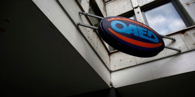 An OAED sign sits above the entrance to a job center in Athens, Greece, on Thursday, June 11, 2015. European Union President Donald Tusk accused Greece of playing games with its future in the euro zone and pressed Prime Minister Alexis Tsipras's government to make concessions in order to escape economic ruin. Photographer: Kostas Tsironis/Bloomberg via Getty Images