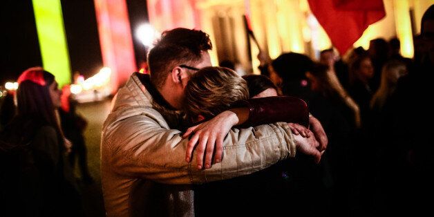BERLIN, March 22, 2016 -- People hug each other as they gather in front of the Brandenburg Gate to mourn over the victims of the Brussels attacks in Berlin, Germany, on March 22, 2016. The German government has strongly condemned on Tuesday the deadly attacks in Brussels that killed as many as 34 people and wounded more than 200. (Xinhua/Zhang Fan via Getty Images)