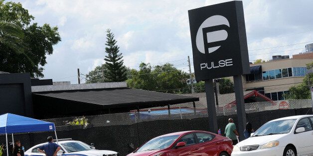 ORLANDO, FLORIDA - JUNE 21: Vehicles cross in front of the Pulse Nightclub on June 21, 2016 in Orlando, Florida. Orlando community continues to mourn deadly mass shooting at gay club. The Orlando community continues to mourn the June 12 shooting at the Pulse nightclub in what is being called the worst mass shooting in American history, Omar Mir Seddique Mateen killed 49 people at the popular gay nightclub early last Sunday. Fifty-three people were wounded in the attack which authorities and community leaders are still trying to come to terms with. (Photo by Gerardo Mora/Getty Images)