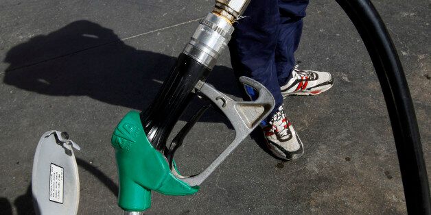 A man waits next to his car at a gas station after concerns of petrol shortages led to panic buying in Athens February 16, 2010. Greek customs officials began a three-day strike on Tuesday, affecting the import of petrol, to protest against cuts in their income in a further sign of discontent among public workers with an EU-backed deficit-cutting plan. REUTERS/Yiorgos Karahalis (GREECE - Tags: BUSINESS POLITICS EMPLOYMENT)