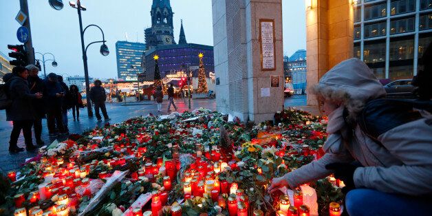 Flowers and candles are placed near the Christmas market at Breitscheid square in Berlin, Germany, December 22, 2016, following an attack by a truck which ploughed through a crowd at the market on Monday night. REUTERS/Fabrizio Bensch