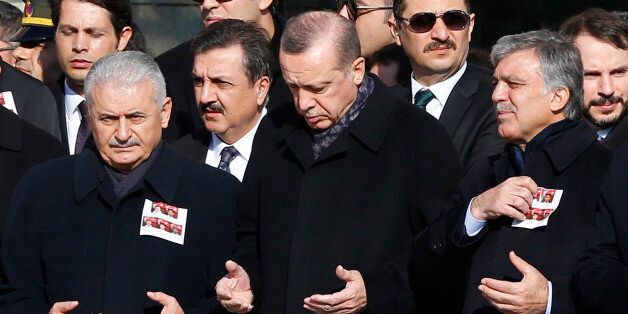 Turkish Prime Minister Binali Yildirim, President Tayyip Erdogan and Former President Abdullah Gul pray during a ceremony for police officers killed in Saturday's blasts in Istanbul, Turkey, December 11, 2016. REUTERS/Murad Sezer
