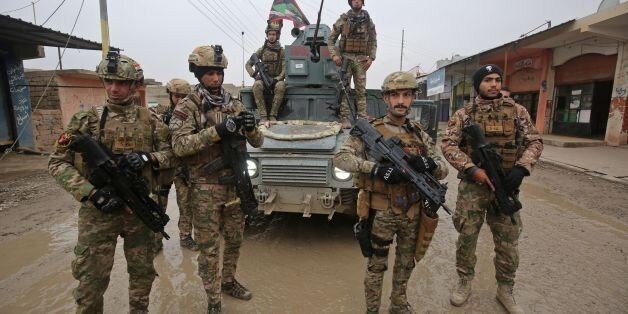 Iraqi pro-government forces patrol the eastern part of the embattled Iraqi city of Mosul on December 28, 2016, during an ongoing military operation against Islamic State (IS) group jihadists.Iraqi forces have advanced into eastern Mosul -- which is divided by the Tigris River -- and have retaken some neighbourhoods on that side of the city, which has been held by the Islamic State group for more than two and a half years. / AFP / AHMAD AL-RUBAYE (Photo credit should read AHMAD AL-RUBAYE/AFP/Getty Images)