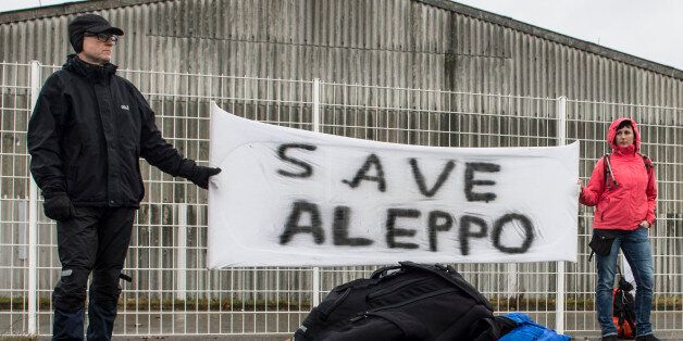 Participants of the solidarity march to Aleppo hold a banner reading 'Save Aleppo' in Berlin,Â Germany, on December 26, 2016.Organised by Polish journalist and blogger Anna Alboth, the 'Civil March for Aleppo' aims to build political pressure to end the bombing of rebel areas by the Syrian regime and its Russian and Iranian backers. / AFP / dpa / Paul Zinken (Photo credit should read PAUL ZINKEN/AFP/Getty Images)