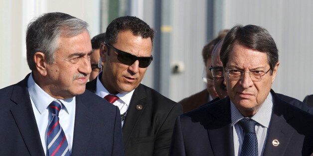 U.N. member of the Committee on Missing Persons (CMP) Paul Henri Arni (R) talks with Greek Cypriot leader and Cyprus President Nicos Anastasiades (C) and Turkish Cypriot leader Mustafa Akinci outside the CMP Anthropological Laboratory in the buffer zone of Nicosia airport December 20, 2015. REUTERS/Yiannis Kourtoglou