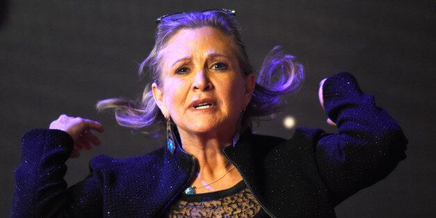 Carrie Fisher poses for cameras as she arrives at the European Premiere of Star Wars, The Force Awakens in Leicester Square, London, December 16, 2015. REUTERS/Dylan Martinez