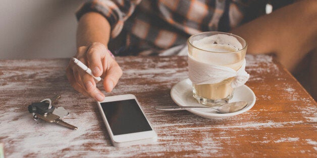 Woman with cell phone in a cafe