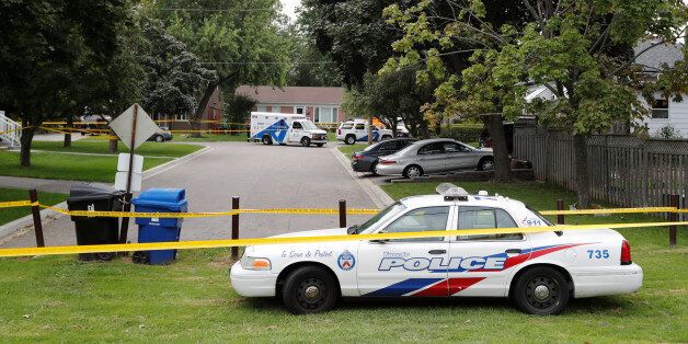 Police are seen at a crime scene in front of a house where three people have died in an incident involving a crossbow in the Scarborough suburb of Toronto, August 25, 2016. REUTERS/Mark Blinch