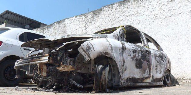 Grab taken from an AFP video showing the burned-out rental car of missing Greek ambassador to Brazil Kyriakos Amiridis, at a parking lot outside the police station in Belford Roxo, in the Brazilian state of Rio de Janeiro, on December 30, 2016, a day after it was found with a body inside.Police have still not confirmed whether the body found in the car was that of the 59-year-old ambassador, who went missing on Monday night. / AFP / Marie HOSPITAL (Photo credit should read MARIE HOSPITAL/AFP/Getty Images)