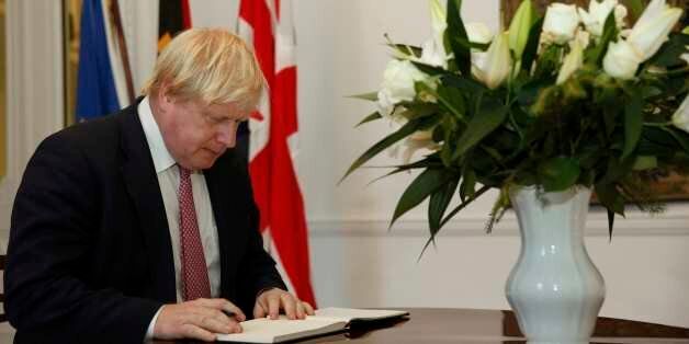Britain's Foreign Secretary Boris Johnson signs a book of condolence for victims of the Berlin truck attack, at the German embassy in London on December 21, 2016. Twelve people were killed when an articulated lorry, laden with steel beams, slammed into a crowded holiday market in the German captial late on December 19, smashing wooden stalls and crushing victims. / AFP / POOL / NEIL HALL (Photo credit should read NEIL HALL/AFP/Getty Images)