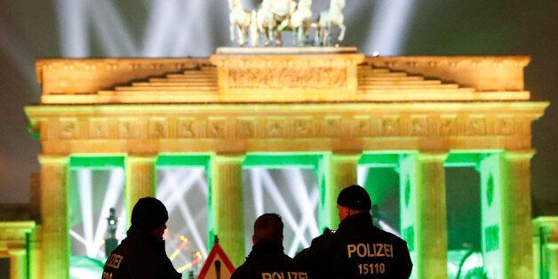 German police men guard the venue at the Brandenburg Gate, during the upcoming New Year's Eve celebrations in Berlin, Germany, December 31, 2016. REUTERS/Fabrizio Bensch