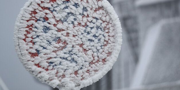 A snow covered traffic sign is pictured at the Feldberg mountain, near Frankfurt, Germany, January 5, 2017. REUTERS/Kai Pfaffenbach