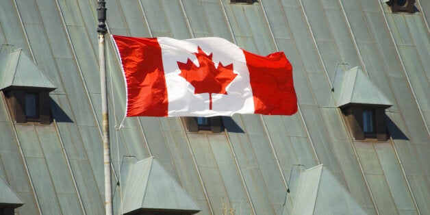 Canadian flag in front of Supreme Court of Canada.