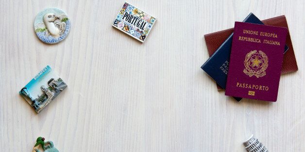 various passports and souvenir magnets from several world country