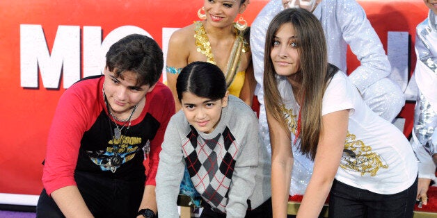 Singer Michael Jackson is immortalized in a ceremony where his children (L-R) Prince, Blanket and Paris use Jackson's shoes and gloves and their own hands to make imprints in cement in the courtyard of Hollywood's Grauman's Chinese Theatre in Los Angeles on January 26, 2012. REUTERS/Phil McCarten (UNITED STATES - Tags: ENTERTAINMENT)