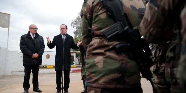 French President Francois Hollande (R) accompanied by French defense minister Jean-Yves Le Drian (L), addresses a group of French soldiers at the Iraqi Counter Terrorism Service Academy on the Baghdad Airport Complex in Baghdad, Iraq, January 2, 2017 at the start of a one-day visit. REUTERS/Christophe Ena/Pool