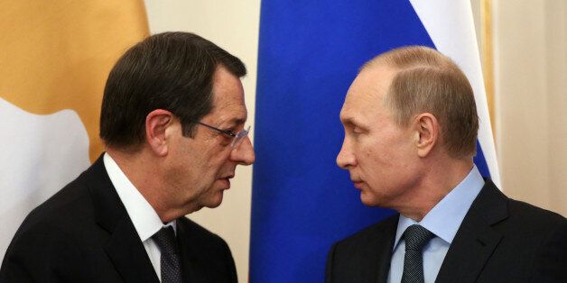 MOSCOW, RUSSIA - FEBRUARY 25: Russian President Vladimir Putin (R) and Cyprus President Nicos Anastasiades (L) during a joint press conference in Novo Ogaryvo State Residence on February 25, 2015 in Moscow, Russia. During his one-day visit to the country, the Cypriot president signed a military agreement which would allow Russian ships to make port calls in Cyprus. (Photo by Sasha Mordovets/Getty Images)
