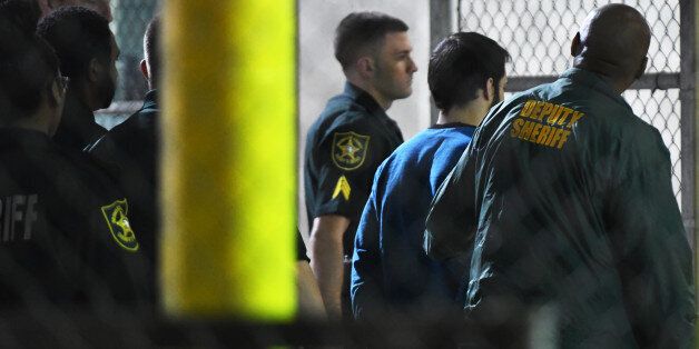 Esteban Santiago, the suspect in the mass shooting at Fort Lauderdale International Airport, is transported to the Broward County Main Jail by authorities on Saturday, Jan. 7, 2017. (Jim Rassol/Sun Sentinel/TNS via Getty Images)