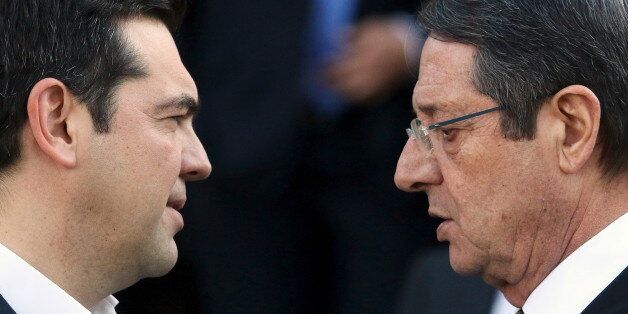 Cypriot President Nicos Anastasiades (R) and Greek Prime Minister Alexis Tsipras talk outside the Presidential Palace in Nicosia, Cyprus January 28, 2016. Greece, Israel and Cyprus will explore the possibility of building a natural gas pipeline to Europe, tapping huge gas reserves discovered in the eastern Mediterranean in recent years, leaders of the three countries said on Thursday. REUTERS/Yiannis Kourtoglou