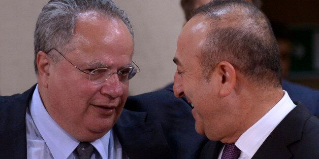 (LtoR) Greek Foreign Affairs Minister Nikolaos Kotzias talks with Turkish Foreign Affairs minister Mevlut Cavusoglu during a foreign affairs ministers meeting at the NATO headquarters in Brussels on May 19, 2016. NATO foreign ministers met to finalise the alliance's biggest military build-up since the end of the Cold War to counter what they see as a more aggressive and unpredictable Russia. At a Warsaw summit in July, NATO leaders will sign-off on the revamp which puts more troops into east European member states as part of a 'deter and dialogue' strategy, meant to reassure allies they will not be left in the lurch in any repeat of the Ukraine crisis. / AFP / JOHN THYS (Photo credit should read JOHN THYS/AFP/Getty Images)