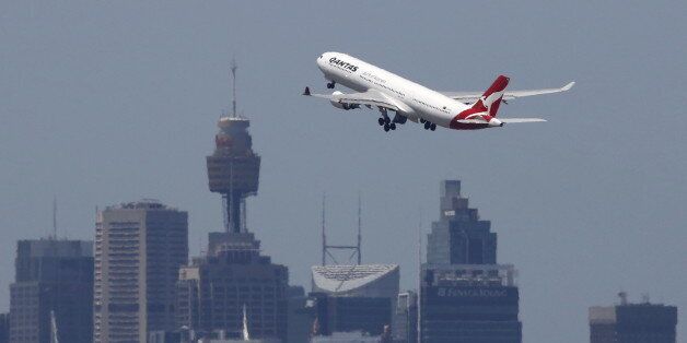 A Qantas Airways Airbus A330-300 jet takes off from Sydney International Airport over the city skyline, December 18, 2015. Australian tax authorities on Thursday took the unprecedented step of publishing the records of hundreds of companies, including Qantas which show they paid little or no tax on their in-country earnings. REUTERS/Jason Reed