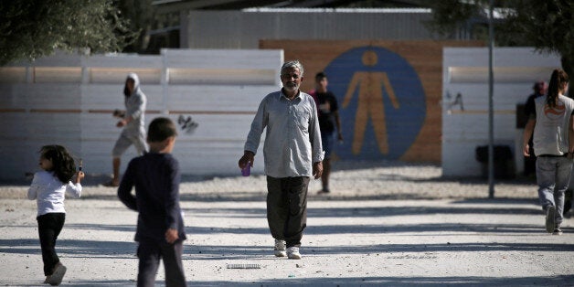 Refugees and migrants make their way at the municipality-run camp of Kara Tepe on the island of Lesbos, Greece October 6, 2016. REUTERS/Alkis Konstantinidis/File photo