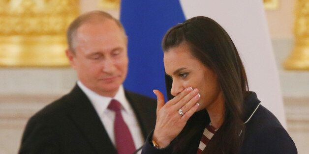 Track-and-field athlete Yelena Isinbayeva reacts as she walks past Russian President Vladimir Putin during his personal send-off for members of the Russian Olympic team at the Kremlin in Moscow, Russia, July 27, 2016. REUTERS/Maxim Shemetov TPX IMAGES OF THE DAY