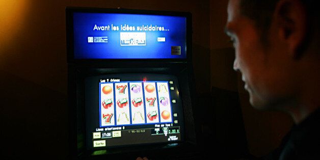 A man looks at a video lottery terminal with the slogan 'Before you have suicidal thoughts.' in Montreal, November 3, 2004 . Story by Miro. (Christinne Muschi/ Toronto Star). (Photo by Christinne Muschi/Toronto Star via Getty Images)